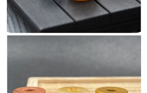 Close-up of assorted natural stone hollow beads for DIY jewelry on a wooden tray