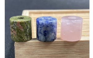 Macro view of cylindrical natural stone beads with smooth edges and vertical holes