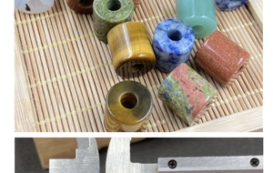 Macro shot measuring natural stone cylinder beads for jewelry making with a caliper