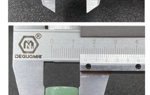 Close-up of a 13mm natural green agate cylinder bead being measured with a caliper