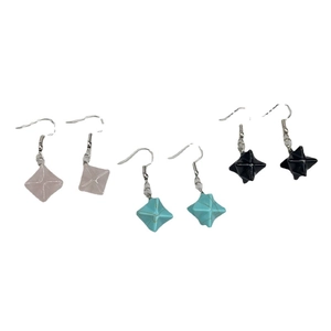 Three pairs of Merkaba geometric crystal star drop earrings in pink, blue, and black