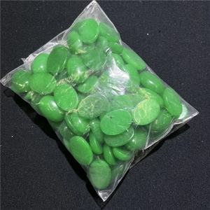Macro detail of 13x18mm green oval agate stones for DIY jewelry and handicraft making