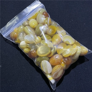 Macro view of 13x18mm oval yellow agate cabochons with natural stripes for DIY jewelry