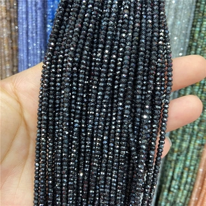 Macro view of multi-faceted 2x3mm black faceted beads for DIY jewelry making