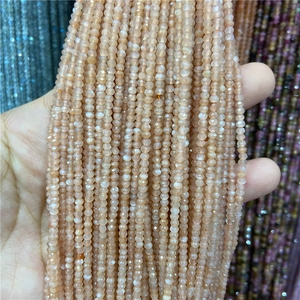 Detailed view of faceted 2-3mm light orange natural stone beads for jewelry making