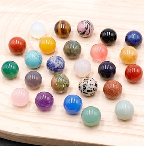 Polished 16mm natural stone spheres including amethyst and tiger eye on wood