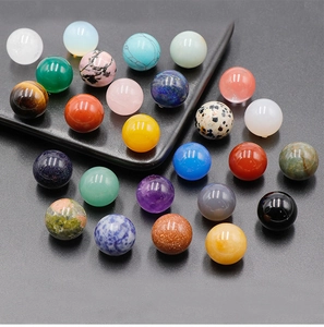 Macro display of diverse 16mm polished natural gemstone spheres showing rich textures
