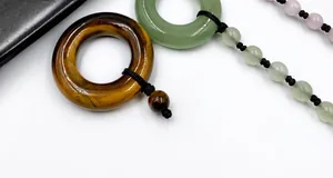Macro shot of tiger eye stone and rose quartz beads with a polished smooth finish