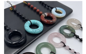 Detailed close-up of natural gemstone pingan kou pendants with colorful braided cords