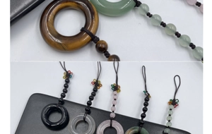Detailed view of woven tiger eye and rose quartz lucky pendants with beaded cords