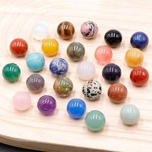 Polished natural 16mm gemstone spheres including amethyst and agate in a wooden tray