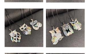 Detailed view of owl pendant necklaces with inlaid natural abalone shell and mother of pearl