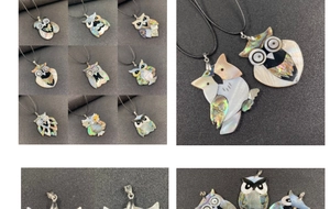 Detail of owl pendant necklace handcrafted with colorful abalone and white shell inlay