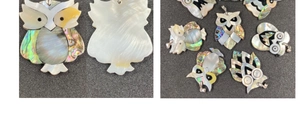 Detailed view of owl pendant crafted with white shell and colorful abalone shell mosaic