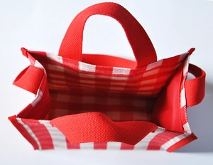 Detailed top view of red and white checkered tote bag showing spacious interior and red handles
