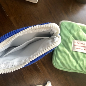 Detailed view of corduroy storage bag interior with pockets and quilted texture
