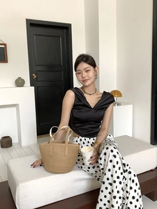 French style straw handbag paired with black satin top and polka dot pants