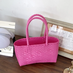 Handmade woven basket bag in vibrant neon pink fuchsia for beach and daily wear