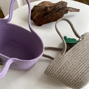 Detail of woven beach tote bags in lavender and beige with thick spiral texture