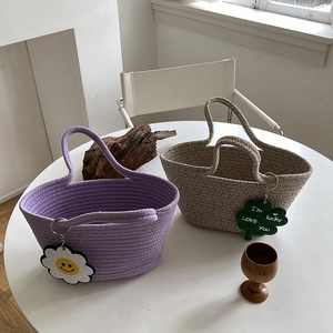 Detail of handmade woven cotton rope bags with daisy and clover lucky charms