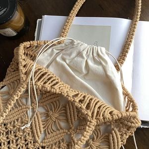 Handmade bohemian macrame straw bag with geometric hollow patterns and drawstring pouch