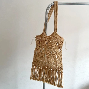 Handmade macrame straw shoulder bag with bohemian tassels and secure drawstring lining
