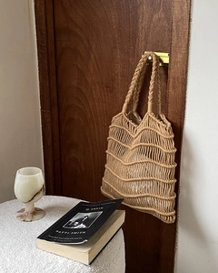 Detailed close-up of handmade woven mesh tote bag with textured wavy knit and inner lining