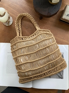 Macro view of macrame woven tote bag featuring cotton rope texture and magnetic clasp