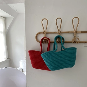 Detailed texture of handmade braided cotton rope bags in vibrant red and lake blue colors