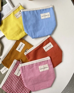 Colorful canvas coin purses with zippers and 'nice to meet you' labels in various colors