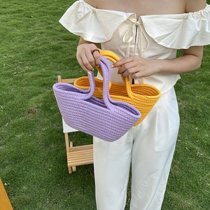 Handmade woven cotton rope bags in lavender purple and yellow on green grass