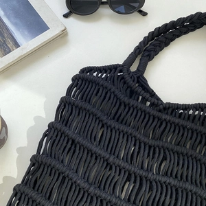 Detail showing the intricate black macrame woven net texture and durable strap design