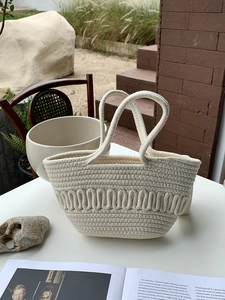 Detail showing thick cotton rope weave and unique wavy texture of the ivory tote bag