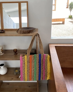 Detailed close-up of multi-color striped crochet straw tote bag with textured weave