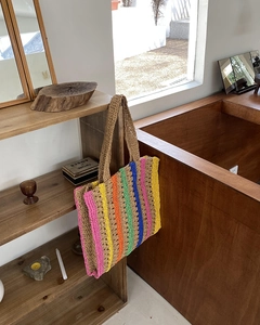 Detail of a colorful striped woven tote bag featuring handcrafted textures and large capacity