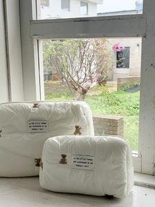 Detailed set of white quilted cosmetic bags with cute bear embroidery and zipper closure