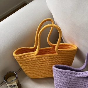 Handmade woven cotton rope tote bags in vibrant orange and lilac for summer beach use