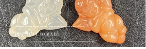Detailed view of translucent angel pendants in white and honey orange agate style