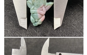 Detailed measurement of hand-carved agate angel pendant showing precise dimensions with calipers