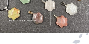 Detail of diverse flower-shaped semi-precious stone pendants with metal bails
