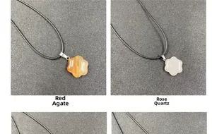 Detail of red agate and rose quartz flower pendants with black adjustable cords