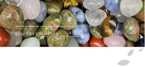 Macro shot of assorted polished natural heart-shaped gemstones and energy crystals