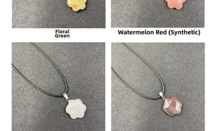 Close-up of cat paw stone pendants in green patterned, pink, white and gray with cords