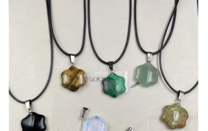 Macro detail of hexagonal star-shaped crystal pendants in obsidian and tiger eye
