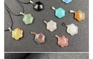 Close-up of hexagonal star and flower stone pendants with assorted colorful gemstone options