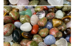 Close-up of polished heart-shaped crystals including rose quartz and tiger eye stones
