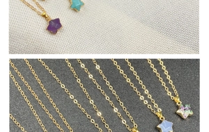 Close-up of star-shaped semi-precious stone pendants with gold plated edges and chains