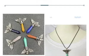 Detail view of gothic skull wing pendant featuring hexagonal crystal stones in various colors