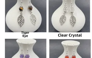 Macro shot of leaf earrings with tiger's eye, amethyst, and quartz gemstones