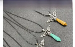 Detail of vintage punk winged skull necklaces with tapered crystal stone pendants